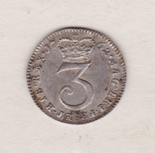 1762 Silver Maundy Threepence coin featuring King George III on the obverse. A central denomination below crown with date divided on the reverse.