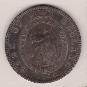 1804 Silver Dollar Five Shillings Coin featuring King George III on the Obverse. The reverse has a seated image of Britannia facing left.