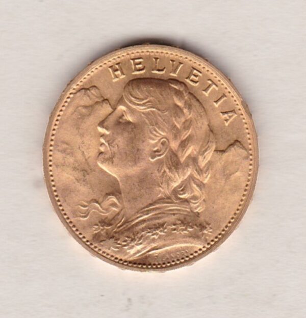 1930 B Switzerland Gold Twenty Francs coin features a female figure on the obverse. The Swiss shield surrounded by oak leaves on the Reverse.