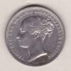 1875 silver shilling coin featuring Queen Victoria young head on the Obverse. The Reverse has a crown, laurel and oak leaves within an open wreath.