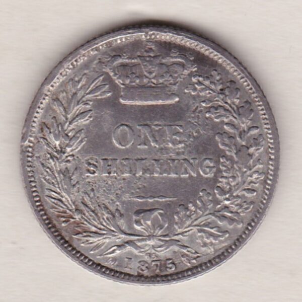 1875 silver shilling coin featuring Queen Victoria young head on the Obverse. The Reverse has a crown, laurel and oak leaves within an open wreath.