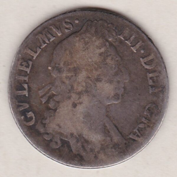 1697 silver shilling coin featuring the laureate or draped bust of William III on the Obverse. The crowned cruciform shields on the Reverse.