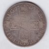 1707 E Silver Halfcrown coin with Queen Anne on the Obverse. Crowned cruciform shields with central Garter stars on the Reverse.