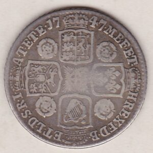 1747 silver shilling coin featuring a laureate and draped bust of George II. The crowned cruciform shields with roses and plumes on the Reverse.