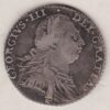 1787 silver shilling coin featuring a laureate and draped bust of George III. The cruciform shields, with a semee of hearts on the Reverse.