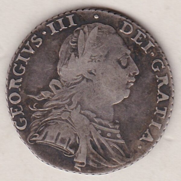 1787 silver shilling coin featuring a laureate and draped bust of George III. The cruciform shields, with a semee of hearts on the Reverse.