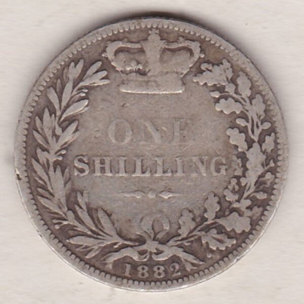 1882 silver shilling coin featuring Queen Victoria young head on the Obverse. The Reverse has a crown, laurel and oak leaves within an open wreath.