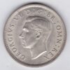 1937 Silver Crown Coin featuring the uncrowned portrait of King George VI on the obverse. A crowned quartered shield of arms on the reverse.