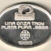 1986 Mexico silver Onza one ounce (Penoles) oval round. This oval round contains one ounce of .9999 fine silver featuring (Penoles) Logo.