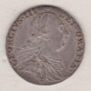 1787 silver shilling coin featuring a laureate and draped bust of George III. The cruciform shields, with a semee of hearts on the Reverse.