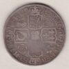 1712 Silver Halfcrown coin with Queen Anne on the Obverse. Crowned cruciform shields with central Garter stars on the Reverse.