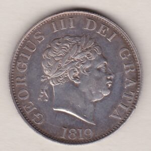 1819 Silver Halfcrown coin with King George III on the Obverse. The reverse features a a crowned and quartered ornate shield of arms.