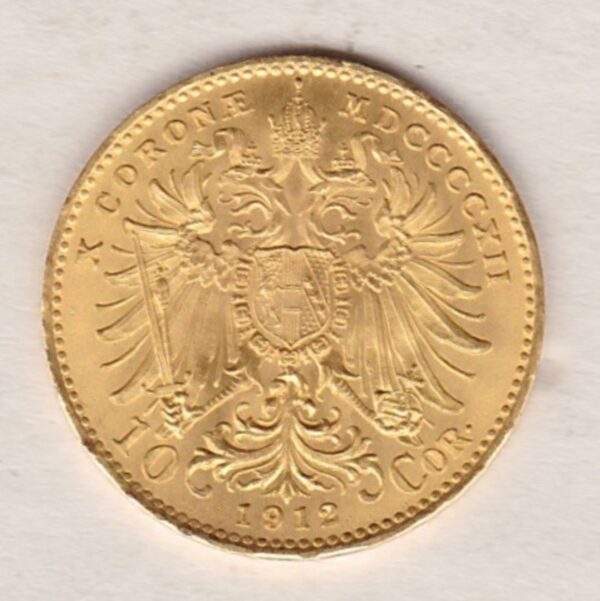 1912 Austria Ten Corona featuring the portrait of Emperor Franz Joseph I on the Obverse. The double-headed imperial eagle is on the Reverse.