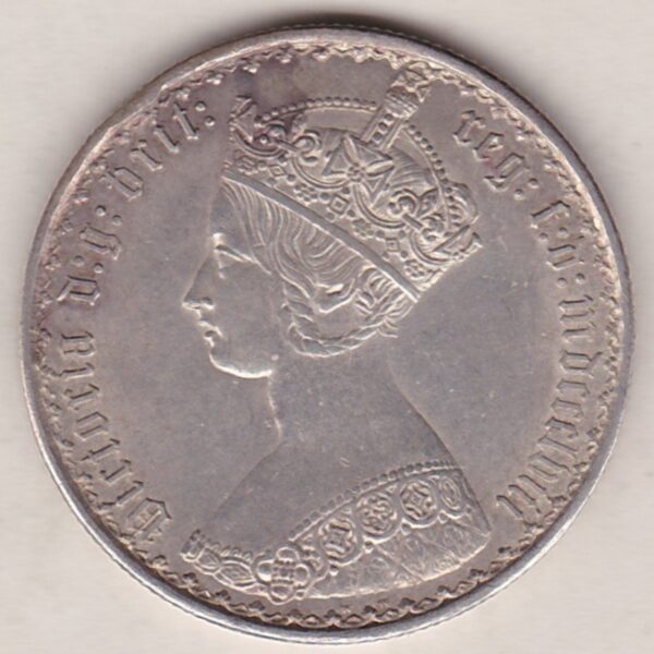 1858 Silver Gothic Florin Coin. The Obverse features a crowned bust of Queen Victoria. The Reverse features a shield with denomination.