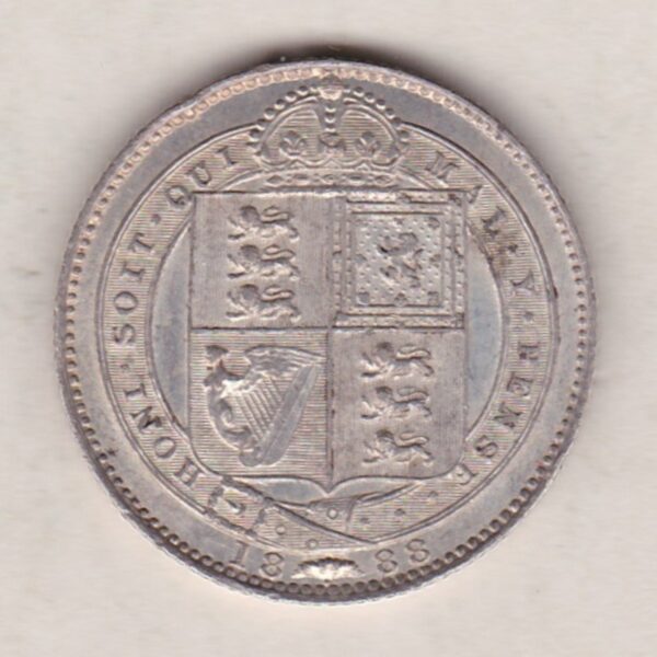 1888 Silver Shilling coin featuring Queen Victoria on the Obverse. The Reverse features the crowned Royal shield within Garter, with divided date below.