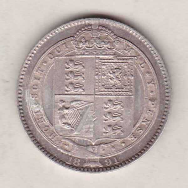 1891 Silver Shilling coin featuring Queen Victoria on the Obverse. The Reverse features the crowned Royal shield within Garter, with divided date below.