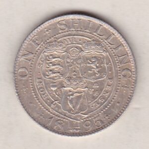 1895 Silver Shilling coin featuring Queen Victoria on the Obverse. The Reverse features the crowned shields of arms with national flower emblems between.