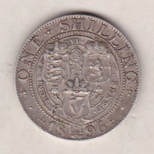 1896 Silver Shilling coin featuring Queen Victoria on the Obverse. The Reverse features the crowned shields of arms with national flower emblems between.