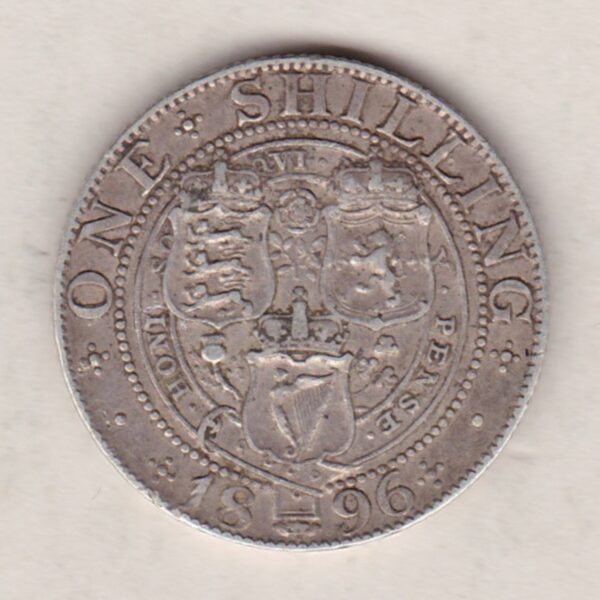 1896 Silver Shilling coin featuring Queen Victoria on the Obverse. The Reverse features the crowned shields of arms with national flower emblems between.