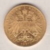 1897 Austria Gold Twenty Corona coin. The obverse features Francis Joseph I. The reverse features the imperial eagle, value and date.