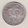 1899 Silver Shilling coin featuring Queen Victoria on the Obverse. The Reverse features the crowned shields of arms with national flower emblems between.