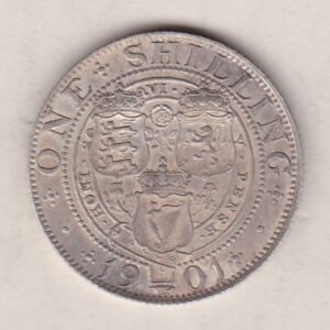 1901 Silver Shilling coin featuring Queen Victoria on the Obverse. The Reverse features the crowned shields of arms with national flower emblems between.