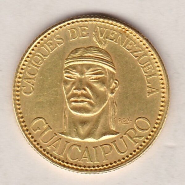 1957 Venezuela Gold Ten Bolivares coin. The obverse features Guaicipuro head. The reverse features a crossed arrows at center.