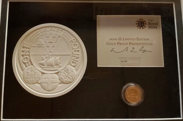 2010 Gold Proof One Pound Belfast coin. This coin comes in a wooden presentation frame with plaster mould and certificate number 0001.