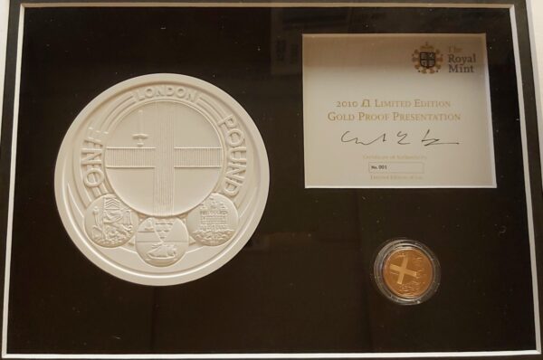 2010 Gold Proof One Pound London coin. This coin comes in a wooden presentation frame with plaster mould and certificate number 001.