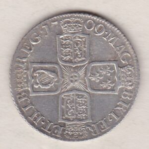 1709 silver shilling coin featuring the draped bust of Queen Anne. The crowned cruciform shields with central Garter star on the Reverse.