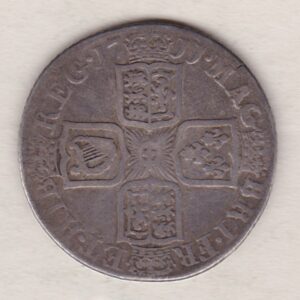 1711 silver shilling coin featuring the draped bust of Queen Anne. The crowned cruciform shields with central Garter star on the Reverse.