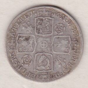 1736 silver shilling coin featuring a laureate and draped bust of George II. The crowned cruciform shields with central Garter star on the Reverse.