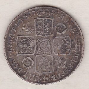 1737 silver shilling coin featuring a laureate and draped bust of George II. The crowned cruciform shields with central Garter star on the Reverse.