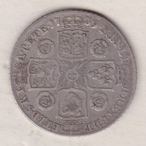 1739 silver shilling coin featuring a laureate and draped bust of George II. The crowned cruciform shields with central Garter star on the Reverse.