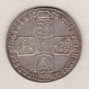 1758 silver shilling coin featuring a laureate and draped bust of George II. The crowned cruciform shields with central Garter star on the Reverse.