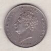 1829 silver shilling coin featuring King George IV on the Obverse. The Reverse has a crowned lion, legend around, national flower emblems below.