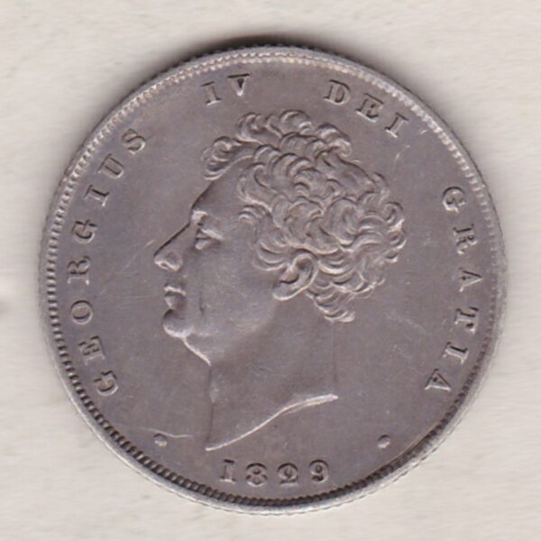 1829 silver shilling coin featuring King George IV on the Obverse. The Reverse has a crowned lion, legend around, national flower emblems below.