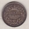 1838 silver shilling coin featuring Queen Victoria young head on the Obverse. The Reverse has a crown, laurel and oak leaves within an open wreath.