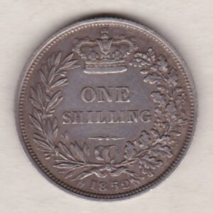 1852 silver shilling coin featuring Queen Victoria young head on the Obverse. The Reverse has a crown, laurel and oak leaves within an open wreath.