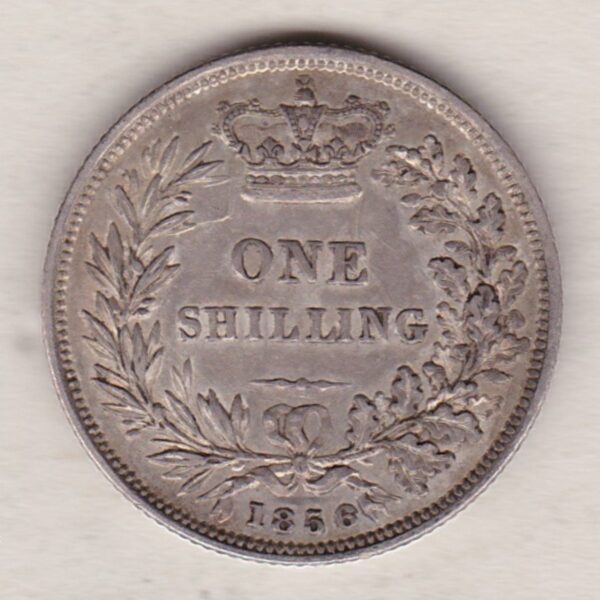 1856 silver shilling coin featuring Queen Victoria young head on the Obverse. The Reverse has a crown, laurel and oak leaves within an open wreath.