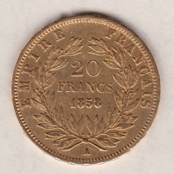 1858 A France Gold Twenty Francs coin featuring Napoleon III on the Obverse. The reverse has the denomination above the date within a wreath.