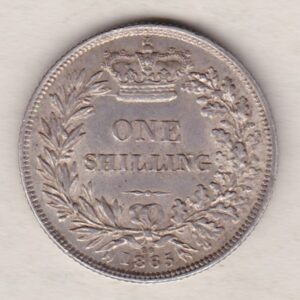 1865 silver shilling coin featuring Queen Victoria young head on the Obverse. The Reverse has a crown, laurel and oak leaves within an open wreath.