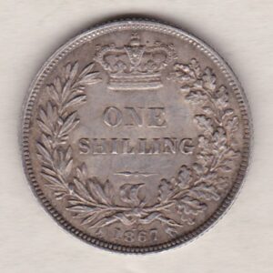 1867 silver shilling coin featuring Queen Victoria young head on the Obverse. The Reverse has a crown, laurel and oak leaves within an open wreath.