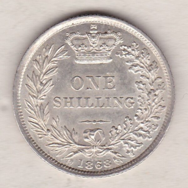 1868 silver shilling coin featuring Queen Victoria young head on the Obverse. The Reverse has a crown, laurel and oak leaves within an open wreath.