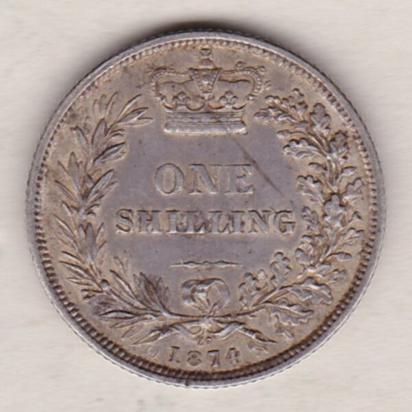 1874 silver shilling coin featuring Queen Victoria young head on the Obverse. The Reverse has a crown, laurel and oak leaves within an open wreath.