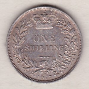 1877 silver shilling coin featuring Queen Victoria young head on the Obverse. The Reverse has a crown, laurel and oak leaves within an open wreath.