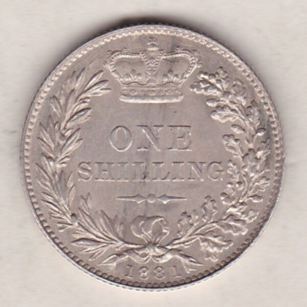 1881 silver shilling coin featuring Queen Victoria young head on the Obverse. The Reverse has a crown, laurel and oak leaves within an open wreath.