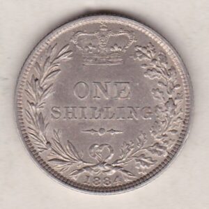 1884 silver shilling coin featuring Queen Victoria young head on the Obverse. The Reverse has a crown, laurel and oak leaves within an open wreath.