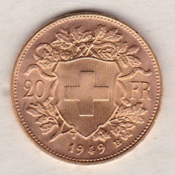 1949 B Switzerland Gold Twenty Francs coin features a female figure on the obverse. The Swiss shield surrounded by oak leaves on the Reverse.