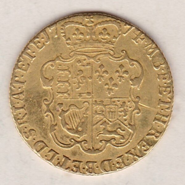 1774 Gold Guinea Coin featuring the fourth laureate head portrait of King George III on the obverse. The crowned quartered shield on the reverse.